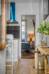 a living room with a kitchen and a bedroom at Lux PIGALLE in Argenteuil