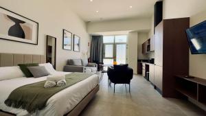 a hotel room with a bed and a living room at Boutique Room - Plaza Tower in Valencia