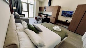a bedroom with a large bed with a couch at Boutique Room - Plaza Tower in Valencia