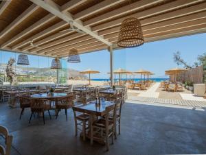 a restaurant with tables and chairs and a view of the ocean at Agrari Ninemia Mykonos in Agrari +20 photos