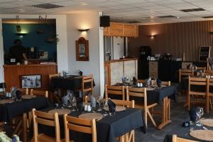 a restaurant with tables and chairs with blue tablecloths at Le Shantoné in Saint-Michel-de-Maurienne
