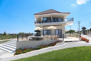 a house with two umbrellas on top of it at Suel Suites Afitos in Afitos
