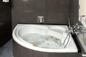 a bath tub with sprinkles in it at Meadows Residency in Ooty +45 photos