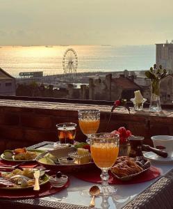 a table with food and drinks and a view of the ocean at Belle Epoque Boutique (Adult Only) in Constanţa