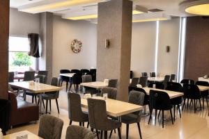 a dining room with tables and chairs at Orty Airport Hotel in İzmir +27 photos