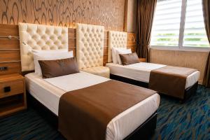 a hotel room with two beds and a window at Orty Airport Hotel in İzmir