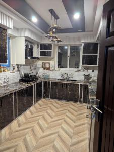 a large kitchen with a large marble counter top at Jasminskardu in Skardu