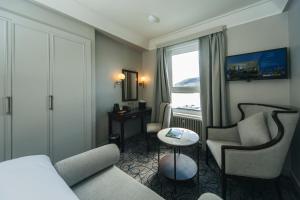 a hotel room with a couch and chairs and a table at The Lochalsh Hotel - Isle of Skye in Kyle of Lochalsh