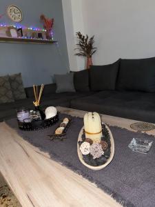a living room with a couch and a table with cookies at John's House in Chalkida