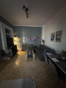 a living room with a couch and a table at John's House in Chalkida