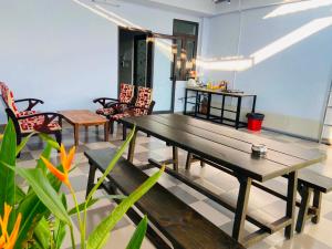 a dining room with a wooden table and chairs at VyVy House Hotel in Tuy Hoa