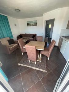 a living room with a wooden table and chairs at Apartmani Blu Notte in Ulcinj