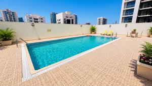 a swimming pool on the side of a building at Amber Tower in Al Ghurayfah