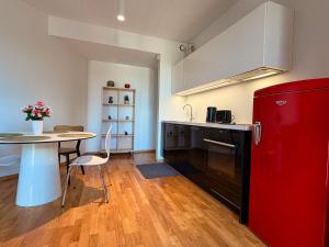 a kitchen with a red refrigerator and a table at Luxury Suites Rotermanni 5 by Rikas Hotels in Tallinn