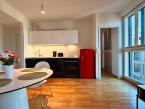 a kitchen with a red refrigerator and a table at Luxury Suites Rotermanni 5 by Rikas Hotels in Tallinn +26 photos