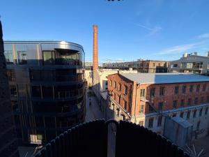 a view of a city with a factory in the background at Luxury Suites Rotermanni 5 by Rikas Hotels in Tallinn