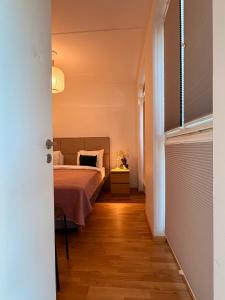 a bedroom with a bed and a table with a lamp at Luxury Suites Rotermanni 5 by Rikas Hotels in Tallinn