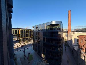 a tall glass building in a city with a factory at Luxury Suites Rotermanni 5 by Rikas Hotels in Tallinn