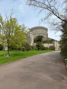 a large castle with a road in front of it at Oakwood Bed and Breakfast Heathrow in Hillingdon