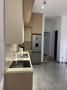 a kitchen with a stove and a refrigerator at Delijorgji Sunrise 4 in Tirana