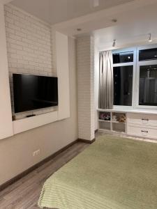 a living room with a flat screen tv on a wall at Pearl KadoRR in Liski