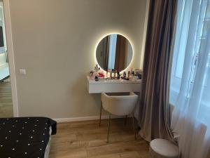 a bathroom with a sink and a mirror at Cosy luxury apartament in Baia Mare +2 photos