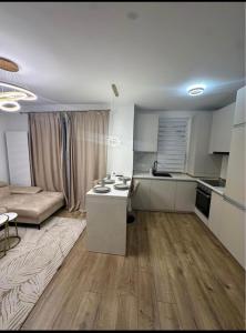 a kitchen and living room with a couch and a table at Cosy luxury apartament in Baia Mare