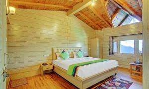 a bedroom with a bed in a wooden room at Hotel Monal Inn, Pangot Wildlife and Bird Sanctuary in Nainital