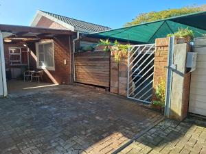 a wooden gate to a house with a fence at Hope Street Studio in Kuilsrivier