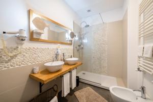 a bathroom with two sinks and a shower at Lula Hotel - Ex Love & Fama Hotel in Sabaudia +75 photos