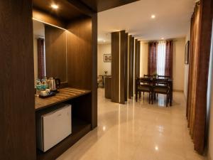 a kitchen with a table and a dining room at Hotel Indraprasttha in Vijayawāda