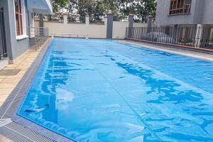a large swimming pool with blue water at PrimeCitySuites in Nakuru