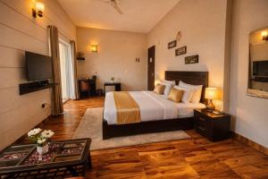 a hotel room with a bed and a television at Onyx Suite Luxury Apartment # Lift # Garden # Ac rooms # Private Parking # Near Prem Mandir # Located Inside- Omaxe Eternity Vrindavan # in Vrindāvan