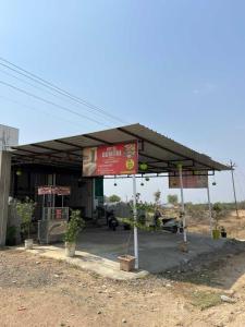 a gas station with a sign in front of it at HOTEL o GUMTHI STAY INN in Patansaongi