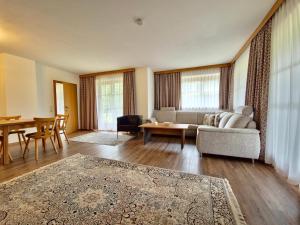 a living room with a couch and a table at Ferienwohnungen Christine in Waidring