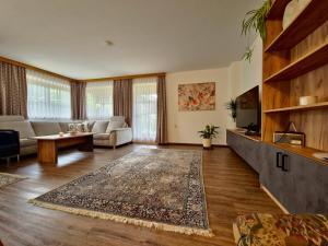 a living room with a couch and a table at Ferienwohnungen Christine in Waidring