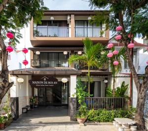 a building with a sign that reads malcolm the hotel inn at Maison De Hoi An Boutique Homestay in Hoi An