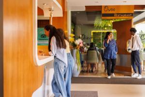a woman standing at a counter in a store at Meadows Residency in Ooty
