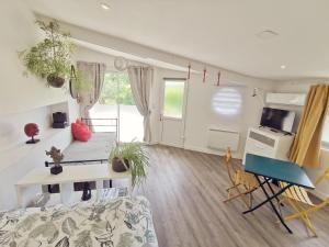 a living room with a couch and a table at Omnia in Saint-Maixent-lʼÉcole