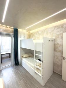 a bedroom with a bunk bed and a window at Apart-Hotel Suites - Qerret, Golem, Durres in Golem