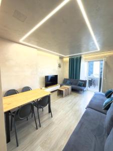 a living room with a couch and a table at Apart-Hotel Suites - Qerret, Golem, Durres in Golem