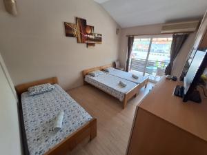 a small room with two beds and a table at Goka apartments in Gevgelija