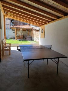 a ping pong table in the middle of a room at Chalet Firefly in Bansko +6 photos