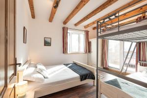 a bedroom with a bunk bed and a window at Chalet Firefly in Bansko