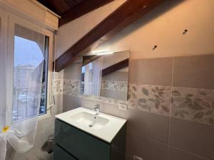 a bathroom with a sink and a mirror at L'Archè - The Rustic Loft in Cinisello Balsamo +7 photos