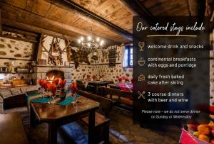 a sign in a restaurant with a table and chairs at Chalet Mila - Total Chalets - Catered Chalet in Bansko