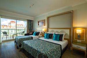 a hotel room with two beds and a balcony at Crystal Waterworld Aqua Collection - Ultimate All Inclusive in Belek +72 photos