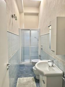 a white bathroom with a toilet and a sink at L'angolo blu in Marettimo