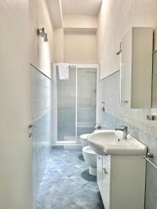 a white bathroom with a toilet and a sink at L'angolo blu in Marettimo