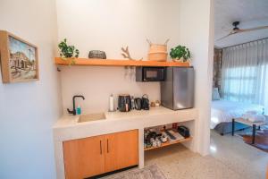 a kitchen with a sink and a microwave at Whale Coast Luxury Suites in Hermanus